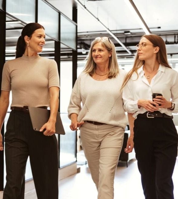 three women walking in an office