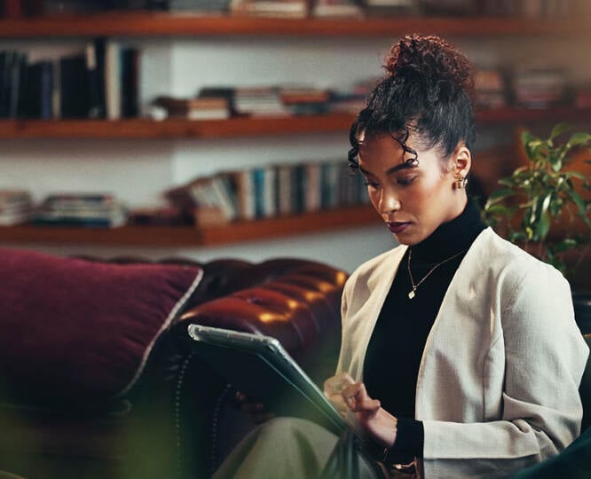 Woman sitting holding a tablet
